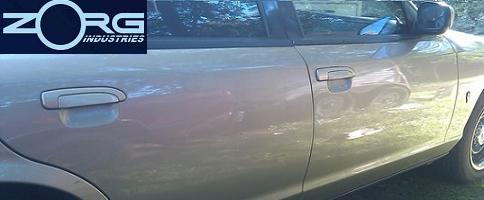 Side view of a tan car door with a Zorg Industries logo in the upper left corner