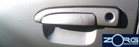 2000 Mercury Grand Marquis - A close-up view of a vehicle's door handle, with a company logo visible.