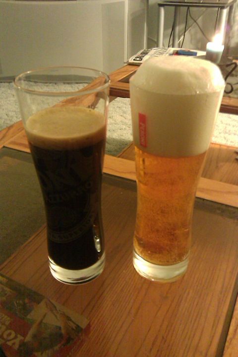 1966 Ford Five Hundred - Two glasses of beer sit on a wooden table, one dark and one light with a foamy head.