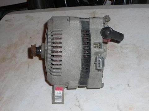 1997 Mercury Grand Marquis - This is an alternator, a component of a vehicle's electrical system, shown here with a label that may contain a part number.