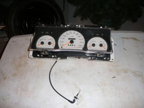 1997 Mercury Grand Marquis - Instrument cluster with multiple gauges and visible text is shown on a table.
