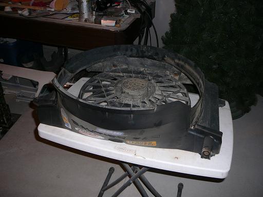 Radiator fan assembly on a white table, with a Christmas tree in the background