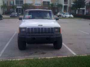 1992 Jeep Cherokee - Front view of a white 1992 Jeep Cherokee parked in a lot.