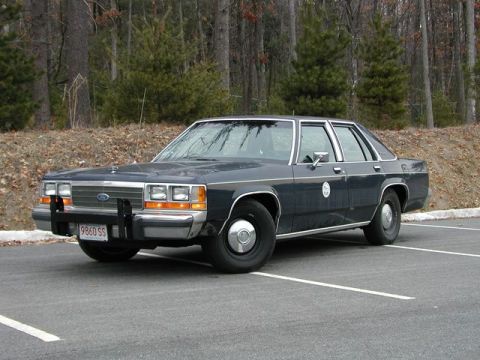 1991 Ford Crown Victoria - This 1991 Ford Crown Victoria police car is seen parked in a lot, showing its distinctive front quarter profile.