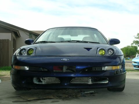 1995 Ford Probe - This blue Ford Probe is shown from the front, yellow headlights and aftermarket intercoolers visible behind the bumper.
