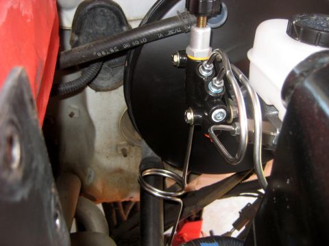 1996 Ford Bronco - Close-up view of the brake booster and master cylinder assembly, showing the intricate network of metal brake lines.