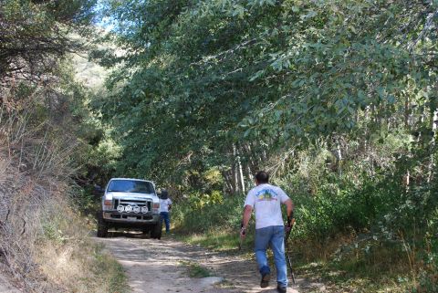 1996 Ford Bronco - A white Ford truck is seen driving on a dirt road surrounded by trees. The truck appears to be a 2005 model.