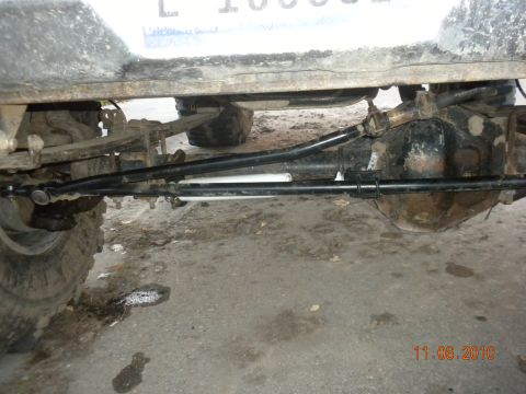1989 Ford Bronco - Close-up of the steering and suspension components on a vehicle's undercarriage.