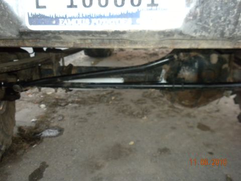 1989 Ford Bronco - Close-up view of the rear axle and suspension components of a vehicle.