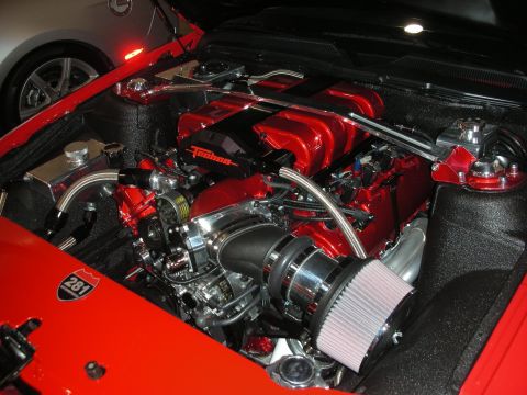 1998 Ford Crown Victoria - detailed engine bay with red intake covers, a chrome supercharger and a conical air filter, marked with a 281 badge.