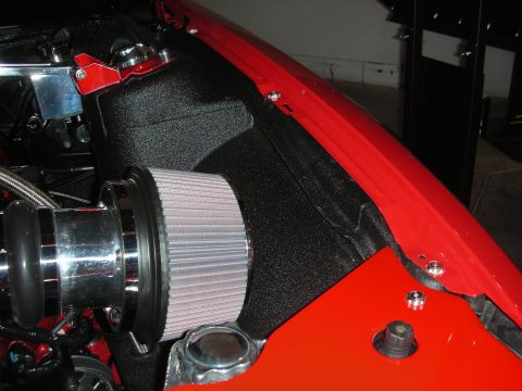 1998 Ford Crown Victoria - Close-up of a conical air filter on a chrome intake tube mounted in a bright red painted engine bay.