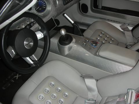 1998 Ford Crown Victoria - light-gray leather interior of a Ford GT showing the carbon-fiber center console, exposed-gate shifter and aluminum-trimmed seats.