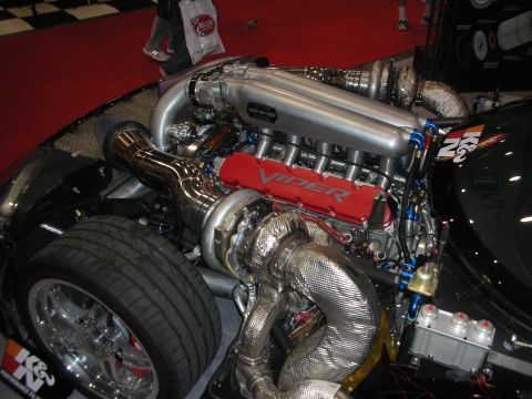 1998 Ford Crown Victoria - highly polished twin-turbo V10 engine with red Viper valve covers displayed in an open engine bay at a show.