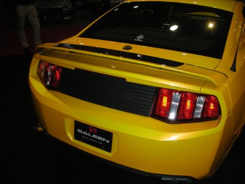 1998 Ford Crown Victoria - Rear three-quarter of a yellow coupe with a black tail panel reading SALEEN above a Saleen-branded plate.