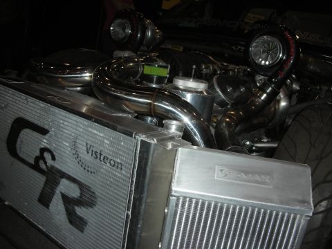 1998 Ford Crown Victoria - C&R aluminum radiator and intercooler with twin turbochargers and polished piping displayed on a show stand.