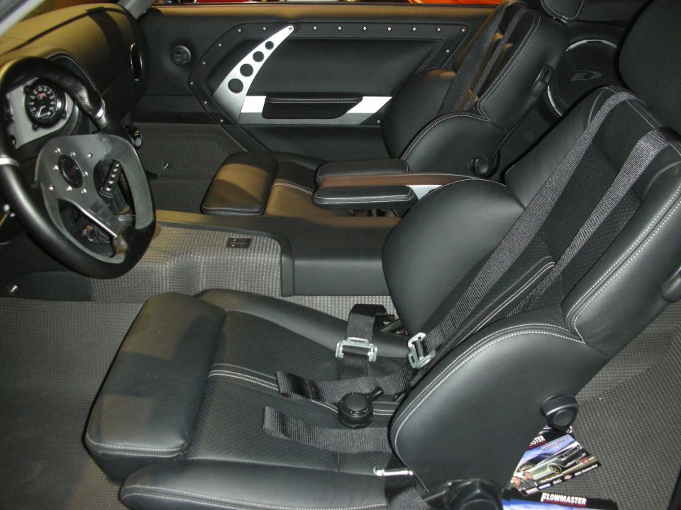 Black custom interior with billet door panels and racing bucket seats