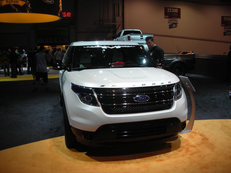 Front of a white Ford Explorer SUV at an indoor show
