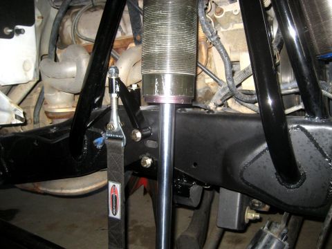 1996 Ford Bronco - Close-up of aftermarket suspension parts, including a shock and tie-down strap.