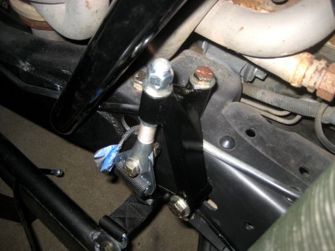 1996 Ford Bronco - Detail of a vehicle's suspension system, focusing on a newly installed bracket and hardware.