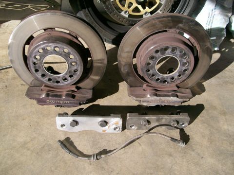 1995 Ford Probe - Pair of performance brake rotors and calipers with associated hardware and brake line.