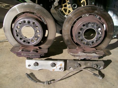 1995 Ford Probe - Pair of Wilwood brake calipers and rotors, along with braided brake lines and mounting hardware.