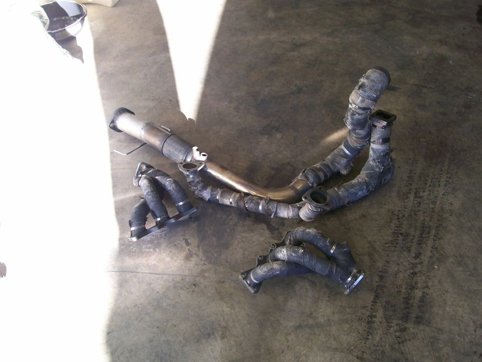 Exhaust manifold and pipe assembly on concrete floor