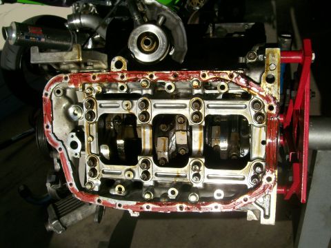 1995 Ford Probe - Engine block with crankshaft and connecting rods visible, oil pan gasket removed.