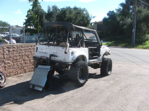 1987 Suzuki Samurai - This modified Suzuki Samurai is viewed from the rear, its off-road enhancements and roll cage.