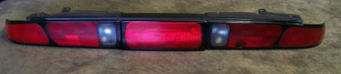 1995 Ford Probe - This is a rear tail light assembly, likely from a car, red brake lights and clear reverse lights.