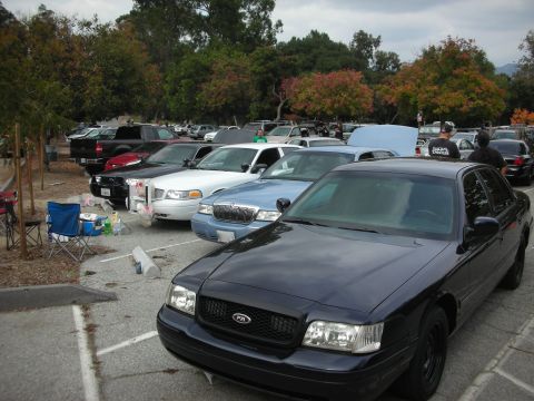 2004 Ford Crown Victoria - A black 2003 Ford Crown Victoria is parked in a lot with other vehicles.