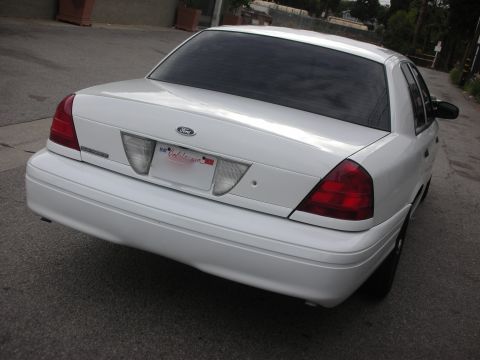 2004 Ford Crown Victoria - Rear view of a white 2004 Ford Crown Victoria sedan parked on a street.