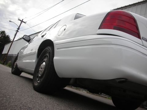 2004 Ford Crown Victoria - Rear view of a white 2004 Ford Crown Victoria sedan parked on a street.