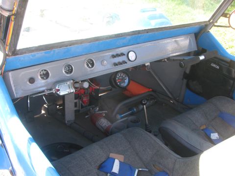 1990 Ford Bronco - Another interior view of a blue off-road buggy showing the gray dash with gauges, shifter and gray cloth seats.