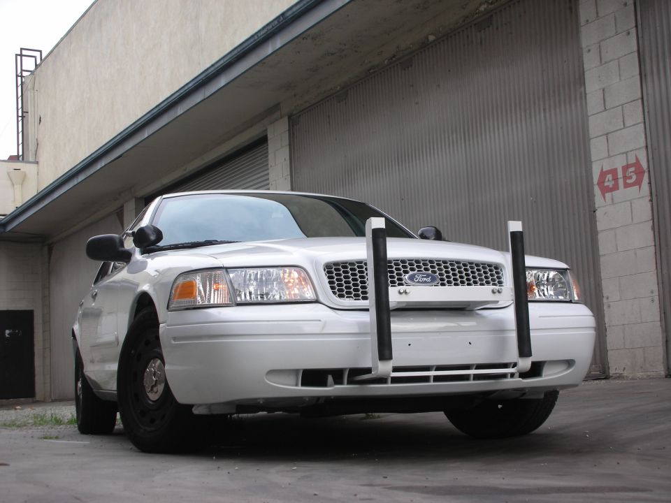 White 2004 Ford Crown Victoria, front view, with push bar and black steel wheels