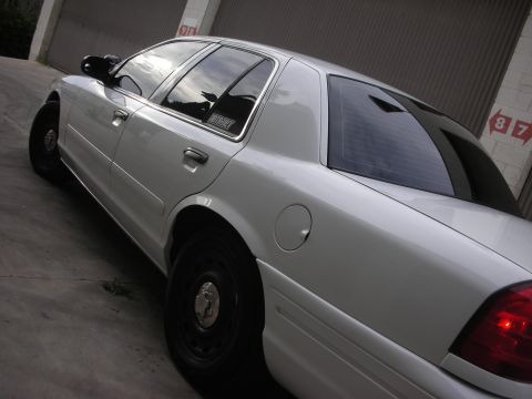 2004 Ford Crown Victoria - Rear quarter view of a white 2004 Ford Crown Victoria sedan.