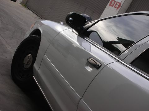 2004 Ford Crown Victoria - This 2004 Ford Crown Victoria is captured in a 3/4 front view, highlighting its side door and fender.