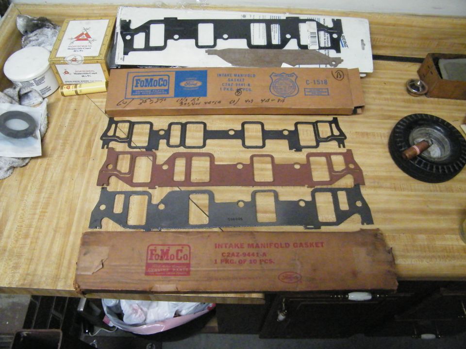 Four V8 intake manifold gaskets on bench with vintage FoMoCo C2AZ-9441 boxes