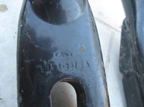 1981 Ford Bronco - Close-up of a black metal part showing a Ford logo and stamped identification numbers.