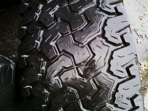1990 Ford Bronco - A close-up view of a tire tread, showing its aggressive pattern.