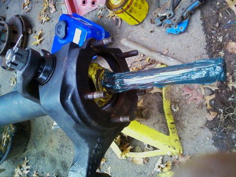 1990 Ford Bronco - Close-up of a greased axle shaft and hub assembly, with a Supermotors logo visible at the bottom right.
