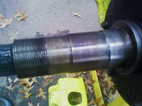 1990 Ford Bronco - Axle shaft with splines and threaded end, part of a vehicle's drivetrain.