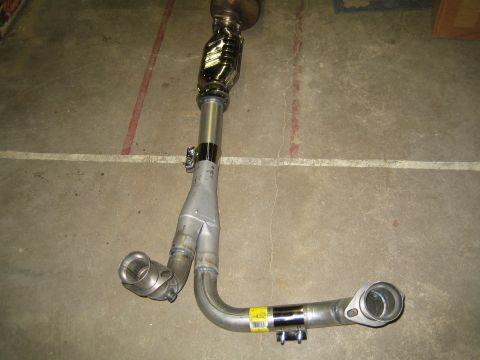 1996 Ford Bronco - An exhaust Y-pipe with a catalytic converter is shown on a concrete floor.