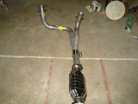 1996 Ford Bronco - Exhaust Y-pipe with catalytic converter shown on a concrete floor.