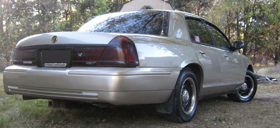 Tan 2000 Mercury Grand Marquis sedan, rear 3/4 view, parked outdoors