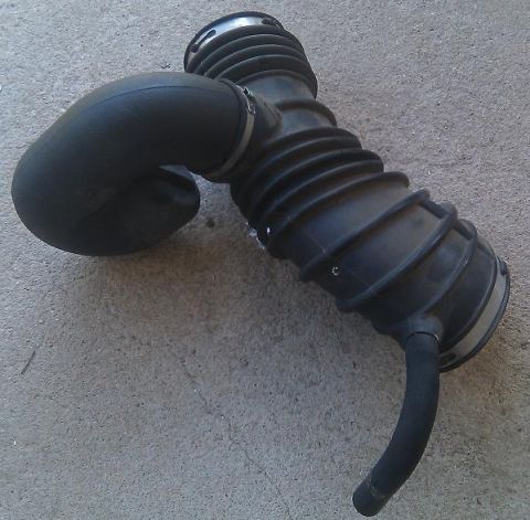 2000 Mercury Grand Marquis - Air intake hose shown on a concrete surface.