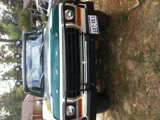 Green 1978 Ford Bronco front view with a black grille guard and a license plate