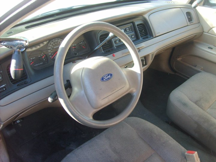 Interior view of a 2004 Ford Crown Victoria showing the dashboard, steering wheel, and seats