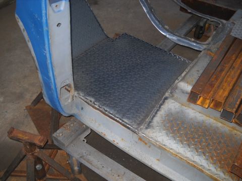 1954 Ford F-100 - The cab floor and lower door frame of a 1954 Ford F-100 undergoing repairs.