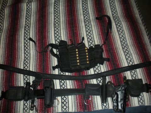 1996 Ford Bronco - Tactical gear, including a vest and duty belt, is displayed on a blanket.