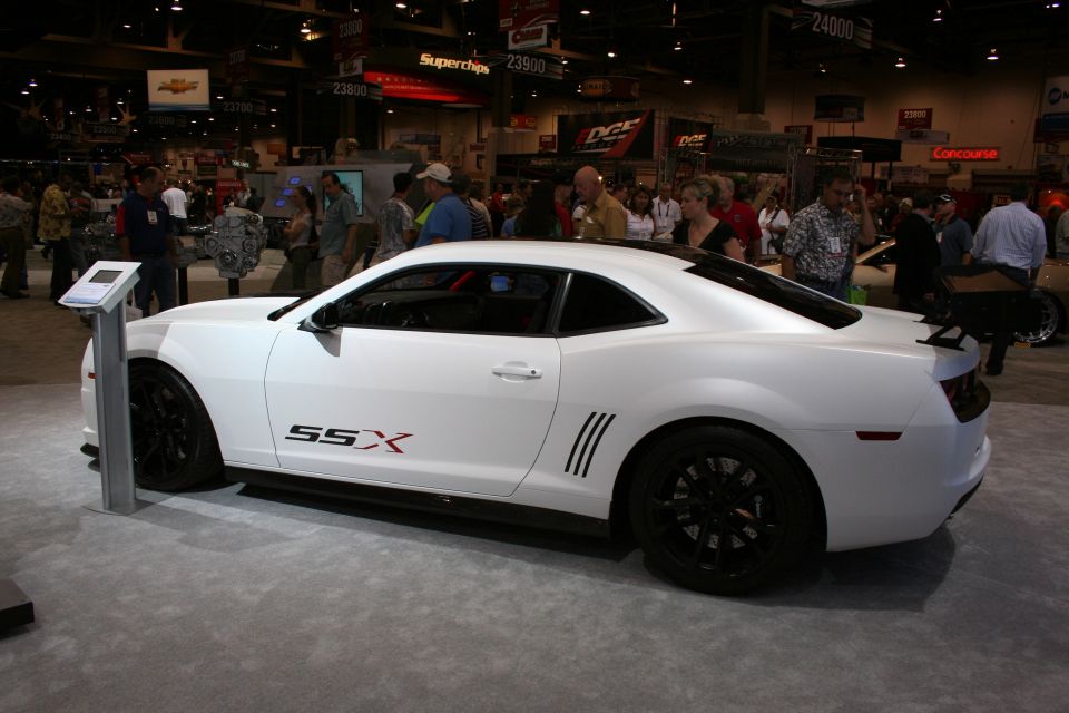 White Chevrolet Camaro coupe with SSX graphics and black wheels at a show